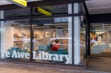 The front of a library with 'Te Awe Library' written in white letters.