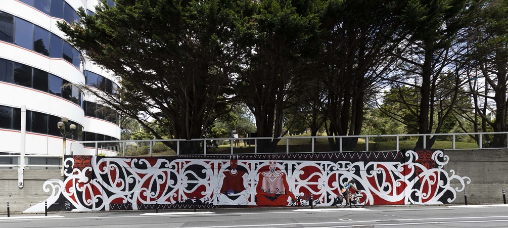 Large mural on Bowen Street, red, white and black with te reo designs.