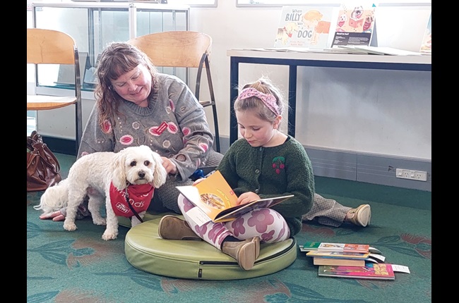 Young ones reading to dogs does the trick