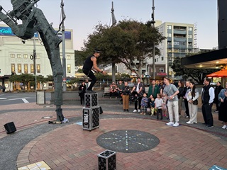 Busker performing under the Tripod stage on Courtenay Place.