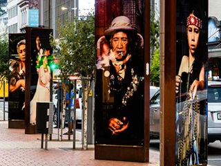 Llight boxes in Courtenay Place displaying photographs by Suzanne Tamaki.