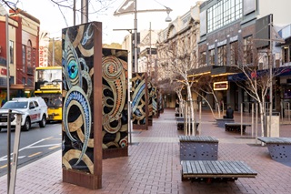 The Courtenay Place light boxes showing a variety of images of traditional Māori designs reminiscent of taniwhā, with orange and blue insets throughout.