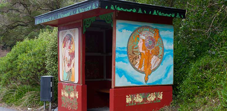 Bus shelter: woman on side with long red hair wearing a head-dress.