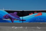 Mural showing dolphin, tug boats and 