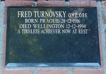 Gravestone reading Fred Turnovsky "A tireless achiever now at rest".