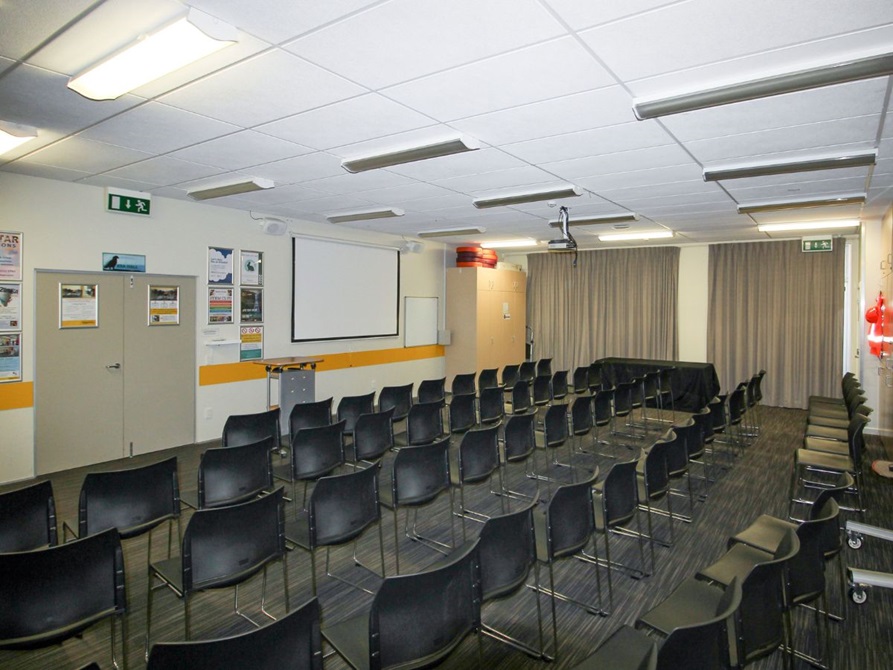  Room with chairs, a projector and a screen.
