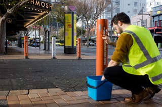 Man in high-vis vest cleaning along Courtenay Place