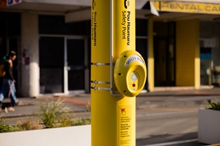 A yellow intercom safety system on a pole in Cuba Street, Wellington.