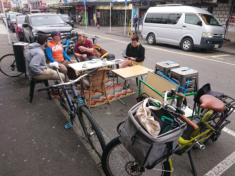 People sitting on Dixon Street as part of a mobile community hub.