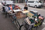 People sitting on Dixon Street as part of a mobile community hub.