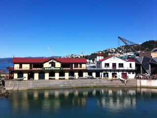 View of Star Boating Club exterior and lagoon in foreground.
