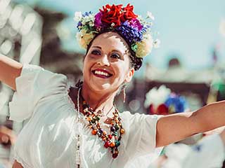 Woman dancing with flowers in her hair.