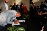 Kura Moehu, Chair of Te Rununganui o Te Āti Awa, signs Tākai Here agreement.