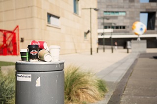 Image of coffee cups piling up in rubbish bin