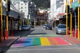 The rainbow crossing in Cuba Street with no pedestrians and only a few parked cars in Dixon Street.