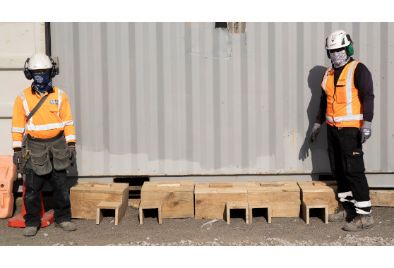 Downer construction workers with five penguin nesting boxes