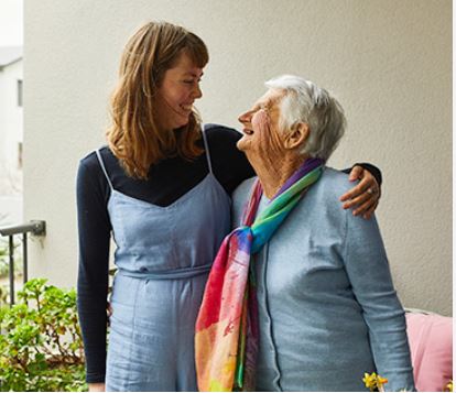 Image of a volunteer and a member of the Aged Concern community
