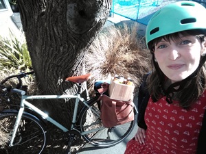Holly Norton from the Sustainable Business Network, with her bike, collecting a zero-waste organic vegan lunch for the judges of the 2020 Wellington Good Food Boost programme.  