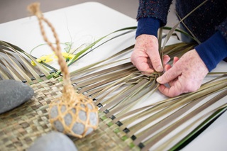 Te Roopu Raranga o Manaia, a Wellington harakeke weaving group, works on Whetūrangi with Maureen Lander