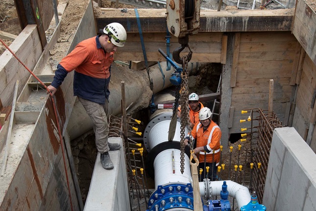 A crew working to install water pipes.