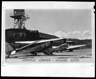 Black and white photo of planes parked on ground at Rongotai airport. 