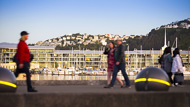 Image of people walking along the waterfront