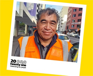 A polaroid photo of Wellington City Council's Pita King, from the Transport and Infrastructure team, in his high-vis vest in the CBD on The Terrace.