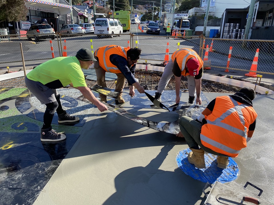 Project workers installing artwork in roundabout in Hataitai