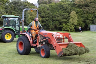 Dave Jackson uses a tractor to pick up grass clippings at Miramar's Polo Ground.