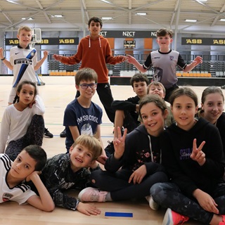 A group of children posing for a photo at the ASB Sport Centre.