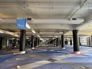 The second floor of the Central Library with no shelves or furniture and the large books banner still hanging from the ceiling.