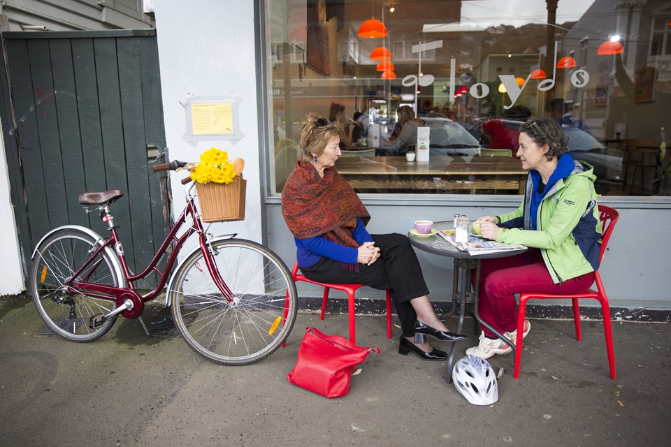 Women enjoy coffee outside cafe in Wellington