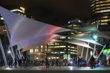 Queens Wharf sails lit up at night for bike event
