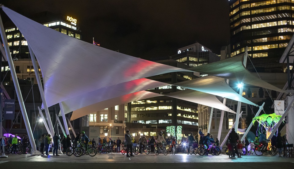 Queens Wharf sails lit up at night for bike event