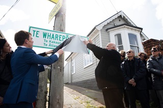 Mayor Andy Foster and local Iwi members remove the cover from the updated street sign for Te Wharepōuri Street in Berhampore.