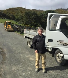 Les standing beside a truck at the Karori Cemetery.