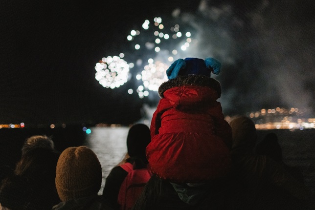 Matariki fireworks child watching on shoulders along the waterfront.