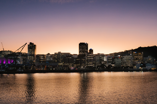 View of the city with the sun setting behind the buildings.