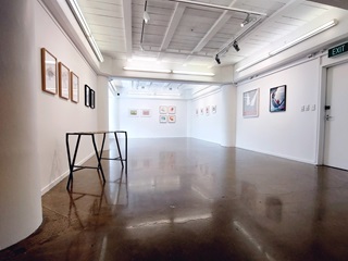 A gallery with art on the walls.