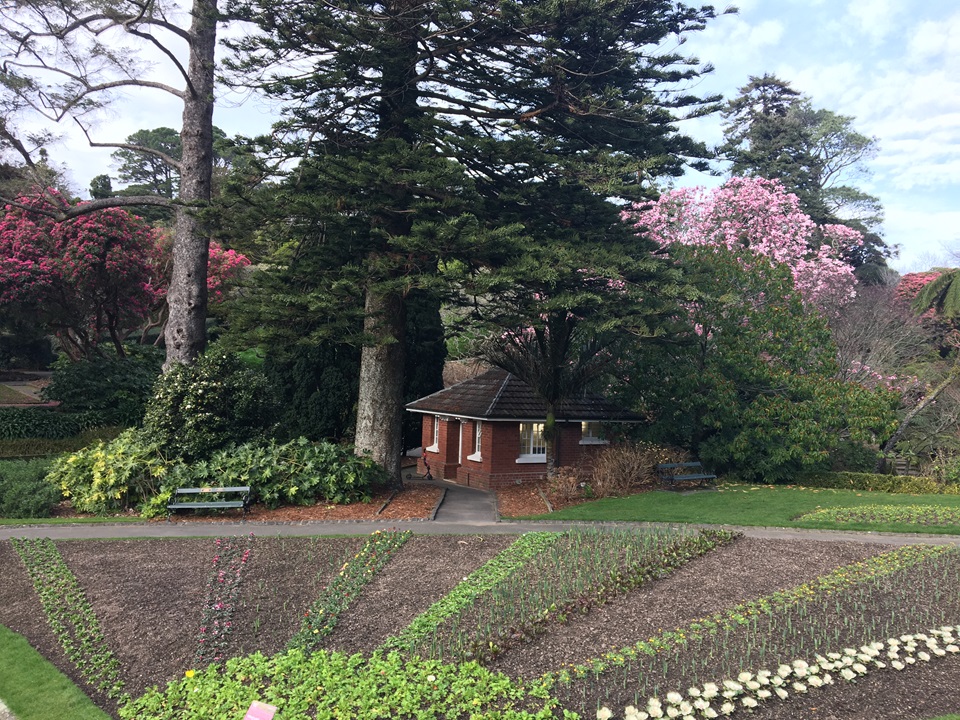Main toilet building in Botanic Garden with spring flowers in background