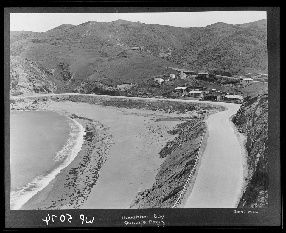 Houghton Bay in 1926 with beach in foreground and a few small wooden houses in background.