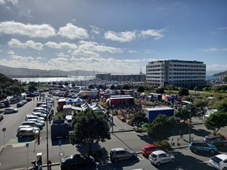 Harbourside Market with cars in the carpark next to it.