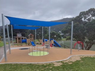 Nairnville park with a blue sail over the top of the playground.