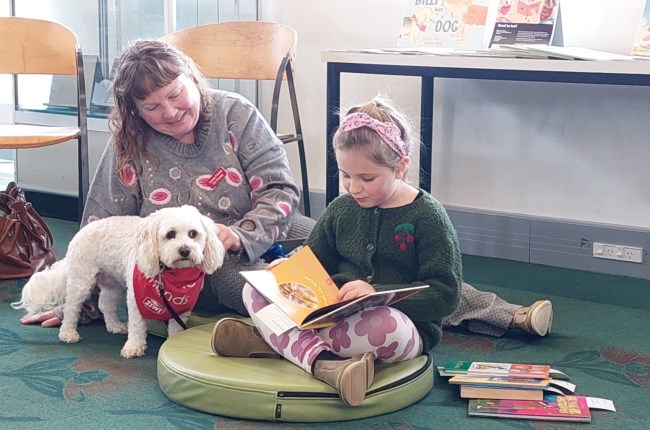 Young ones reading to dogs does the trick