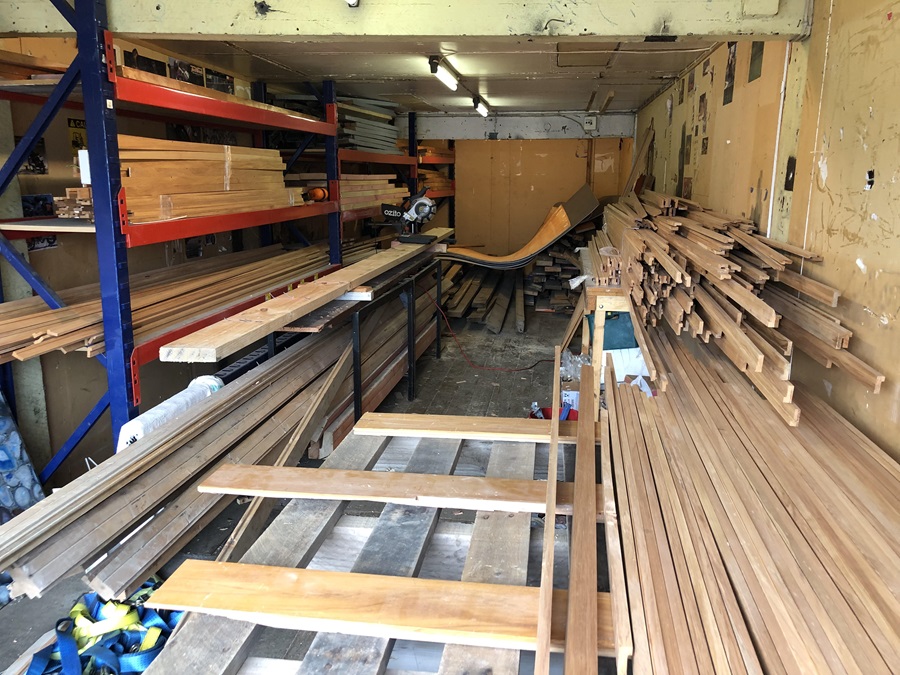 Piles of wood in a shed.