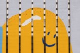 Yellow creature pained onto a fence.