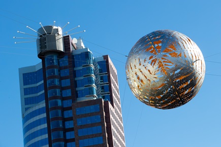 Ferns sculpture suspended above Civic Square with Majestic building in the background.