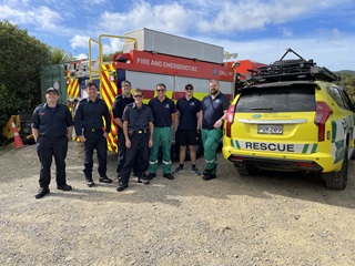 Paramedics and firefighters on top of Makara Peak smiling for a group photo.