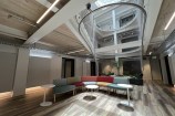 Indoor searing with multicoloured chairs and small white tables.