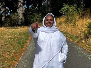 A person standing and pointing at the camera.